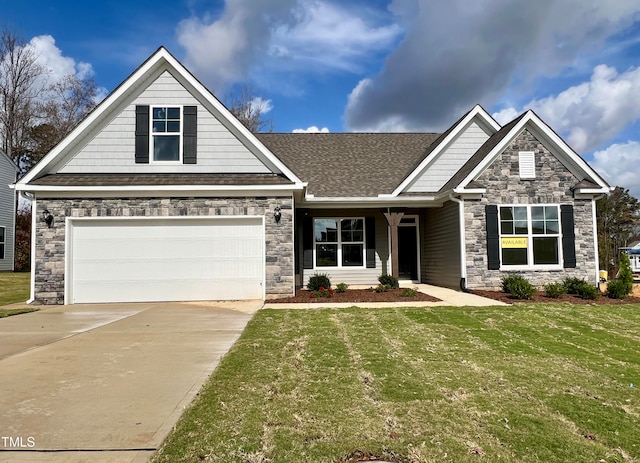 craftsman inspired home featuring a garage and a front lawn