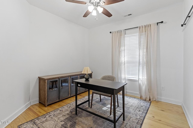 home office with hardwood / wood-style flooring, ceiling fan, and a healthy amount of sunlight