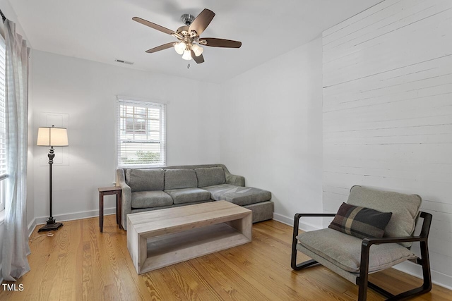 living room featuring ceiling fan and light hardwood / wood-style flooring