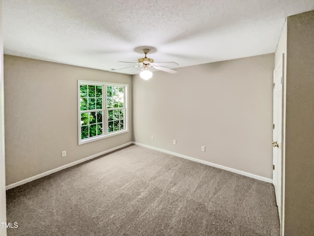 carpeted empty room with ceiling fan and a textured ceiling