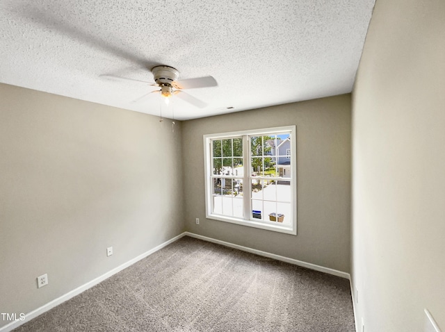 empty room featuring carpet, ceiling fan, and a textured ceiling