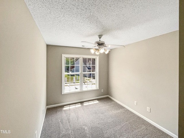 carpeted empty room with ceiling fan and a textured ceiling