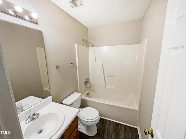 full bathroom with vanity, a textured ceiling, shower / tub combination, hardwood / wood-style floors, and toilet