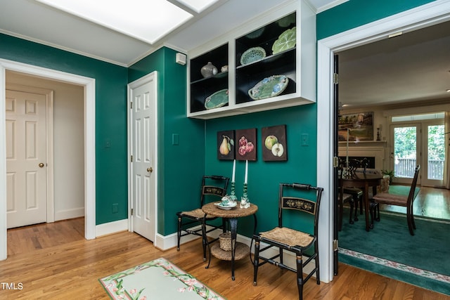 interior space featuring hardwood / wood-style floors and crown molding