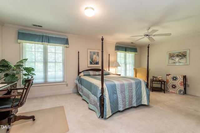 carpeted bedroom featuring multiple windows, ceiling fan, and crown molding