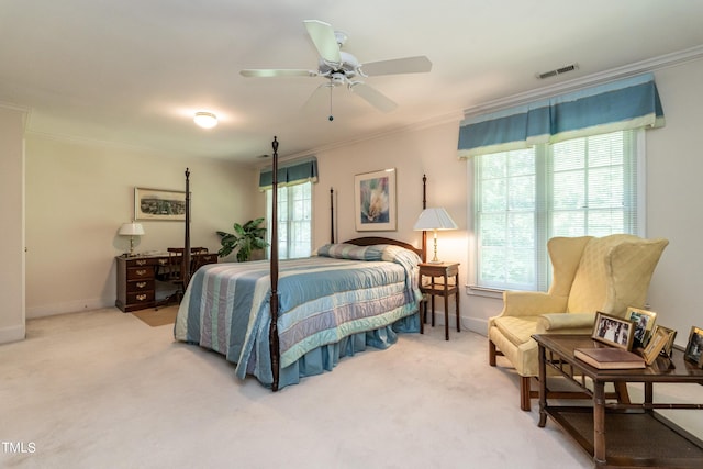 carpeted bedroom featuring ceiling fan and ornamental molding