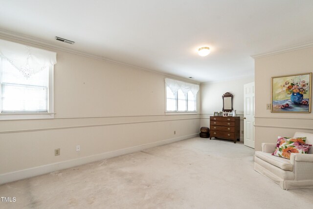 sitting room with carpet and crown molding