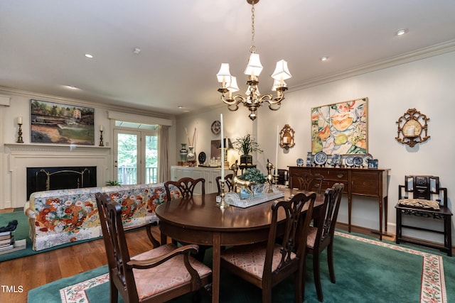 dining room featuring wood-type flooring, an inviting chandelier, and ornamental molding