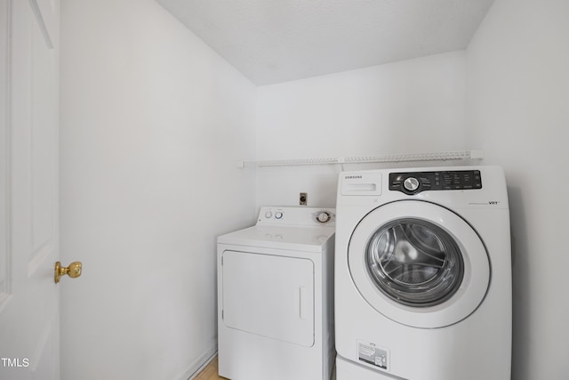 clothes washing area with laundry area and washer and dryer