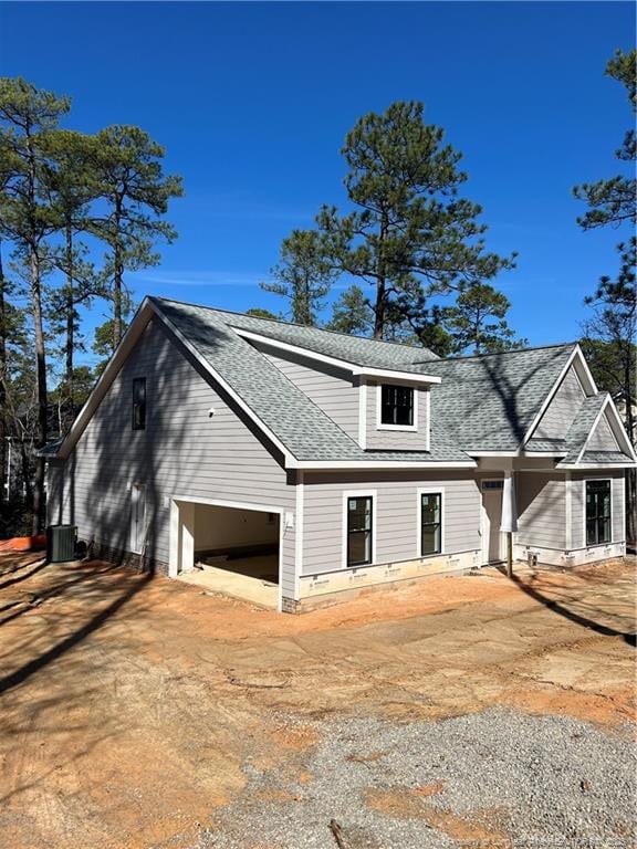 view of front of property with central AC unit and a garage