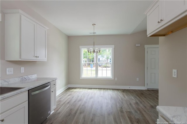 kitchen featuring wood finished floors, white cabinetry, baseboards, light countertops, and dishwasher