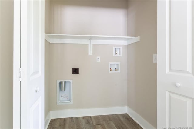 clothes washing area with laundry area, baseboards, dark wood-style floors, hookup for a washing machine, and electric dryer hookup