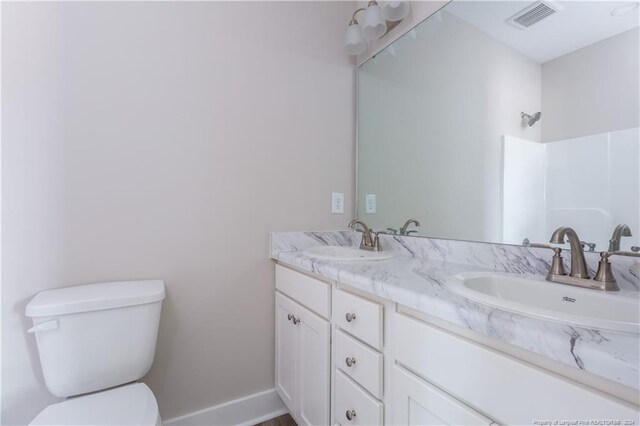 bathroom with toilet and vanity