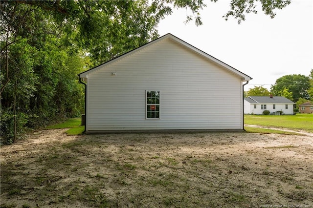 view of home's exterior with a lawn