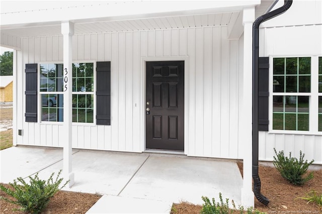 view of exterior entry featuring board and batten siding