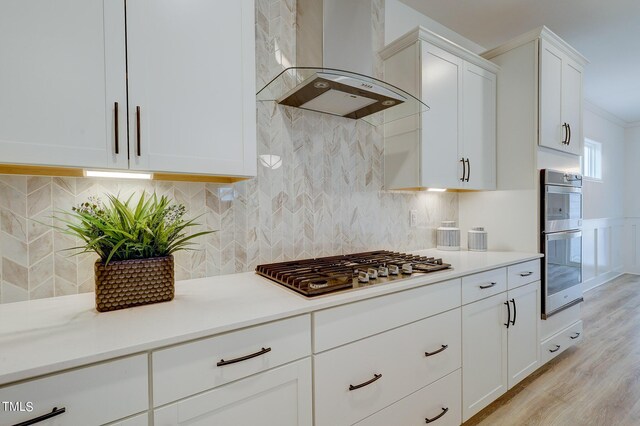 154 Swain St, Clayton, NC 27527 - kitchen with stainless steel appliances, tasteful backsplash, white cabinets, and exhaust hood