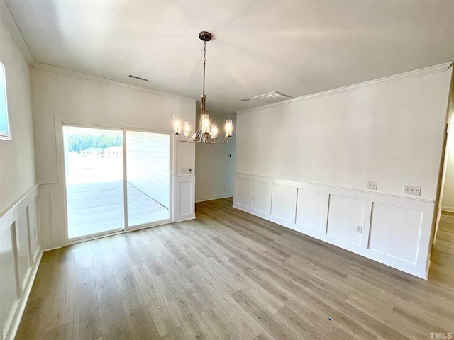 154 Swain St, Clayton, NC 27527 - unfurnished dining area with light hardwood / wood-style floors, crown molding, and an inviting chandelier