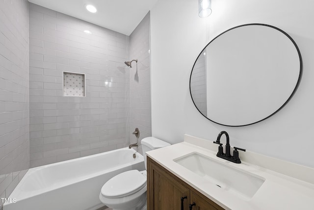 full bathroom featuring toilet, tiled shower / bath combo, and vanity