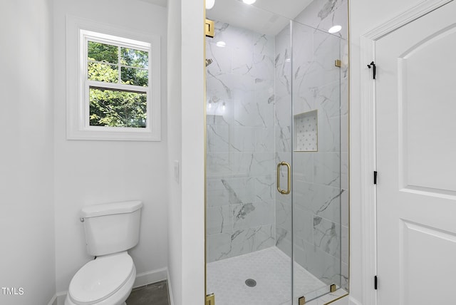 bathroom with an enclosed shower and toilet