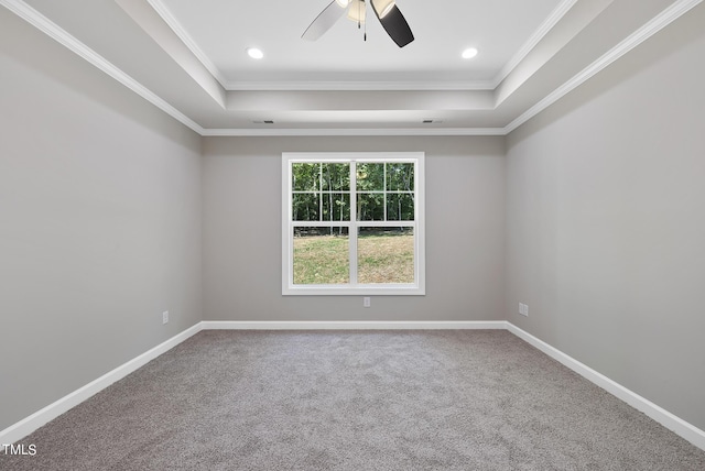 unfurnished room featuring ceiling fan, crown molding, carpet floors, and a tray ceiling