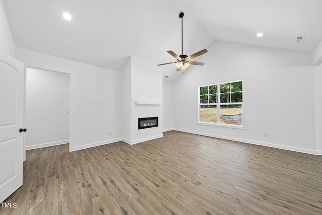 unfurnished living room with hardwood / wood-style flooring, lofted ceiling, and ceiling fan