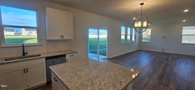 kitchen with white cabinetry, dishwasher, dark hardwood / wood-style floors, and sink