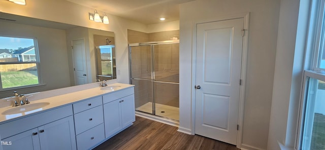 bathroom featuring hardwood / wood-style floors, vanity, and an enclosed shower