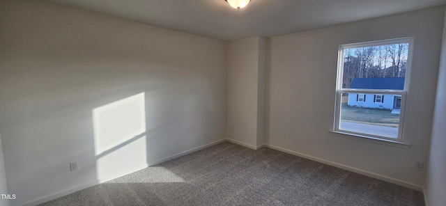 carpeted empty room featuring plenty of natural light