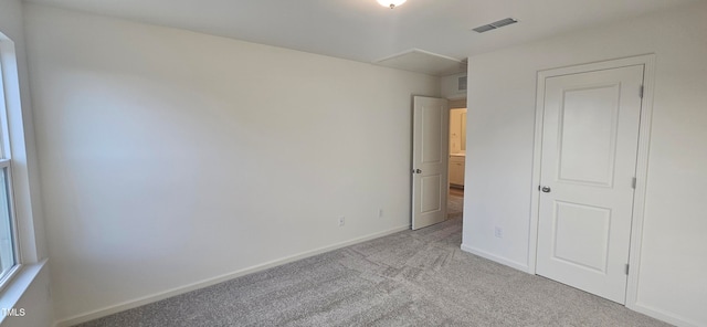 unfurnished bedroom featuring light colored carpet