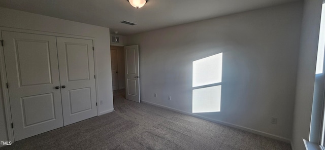 unfurnished bedroom featuring a closet and carpet floors