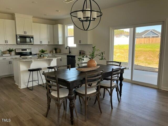 466 Saint Clair Dr, Fuquay Varina, NC 27526 - dining room with a chandelier, dark wood finished floors, and recessed lighting