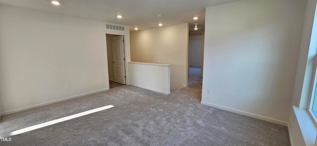 carpeted empty room featuring recessed lighting, visible vents, and baseboards