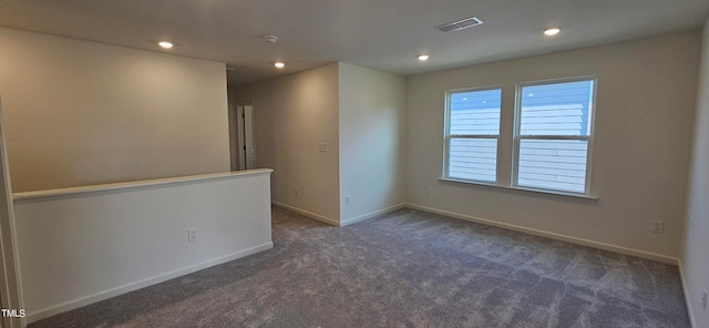 carpeted spare room with recessed lighting, visible vents, and baseboards