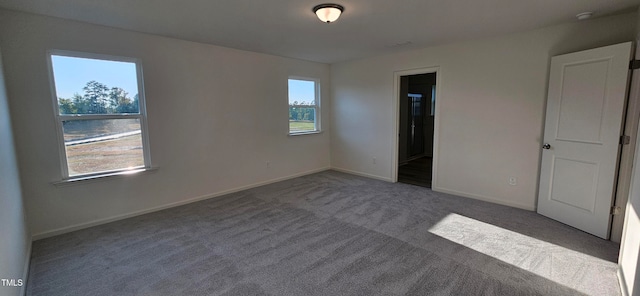 unfurnished bedroom with carpet, ensuite bath, and baseboards