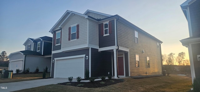 property exterior at dusk featuring a garage and concrete driveway