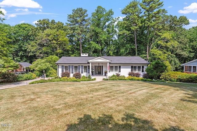 ranch-style home with a porch and a front lawn