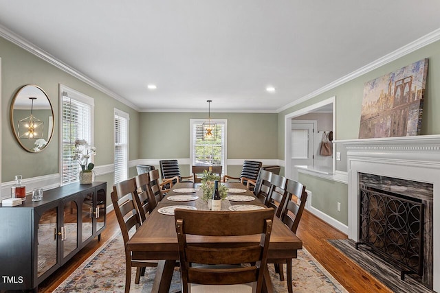 dining area with a chandelier, crown molding, and dark wood-type flooring