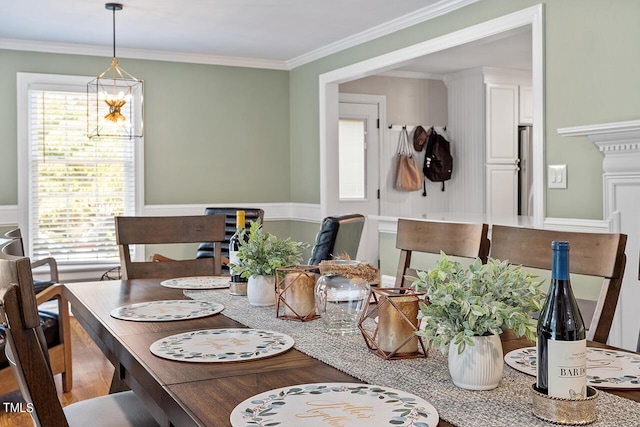 dining area featuring wood-type flooring and ornamental molding