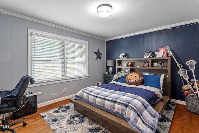 bedroom with dark hardwood / wood-style flooring, ornamental molding, and wooden walls