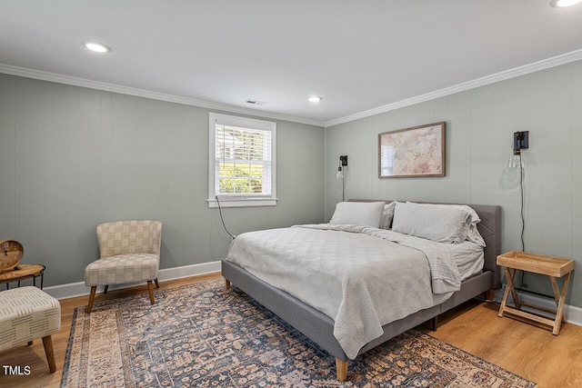 bedroom featuring ornamental molding and hardwood / wood-style flooring