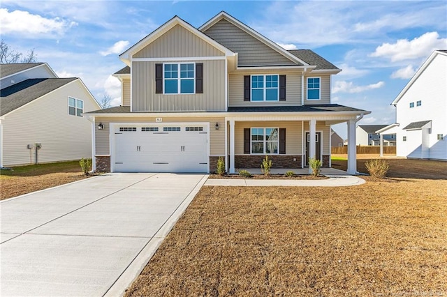 craftsman-style home with a front lawn, a porch, and a garage