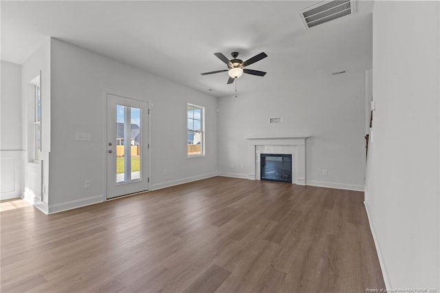 unfurnished living room with ceiling fan and light wood-type flooring