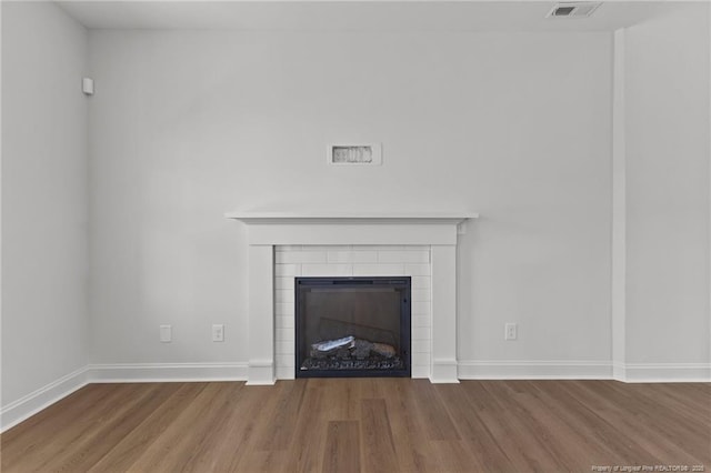 room details with hardwood / wood-style floors and a fireplace