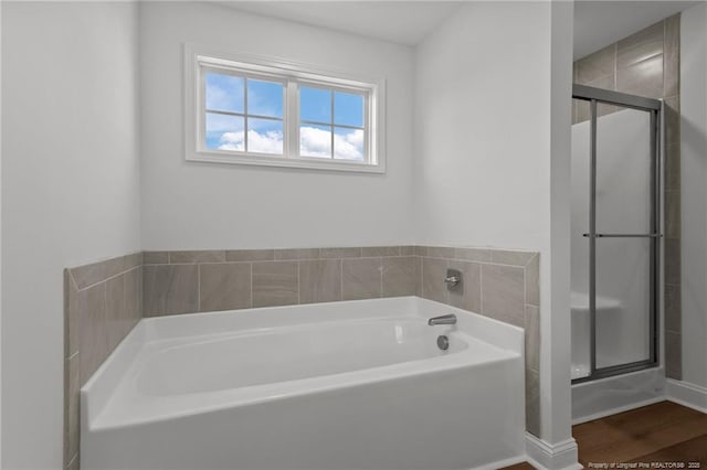 bathroom featuring hardwood / wood-style floors and independent shower and bath