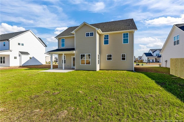 rear view of house featuring a patio and a yard