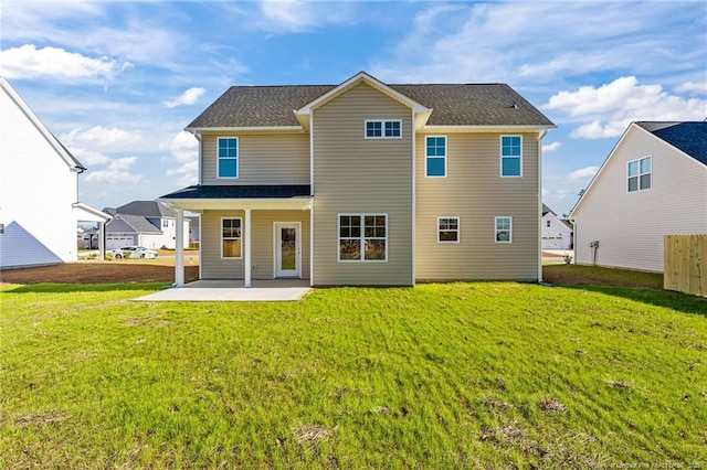 rear view of property featuring a patio area and a lawn