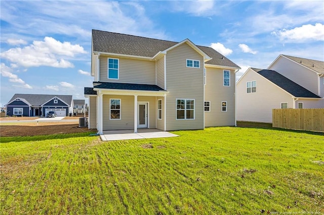 back of property featuring central AC, a patio, and a yard