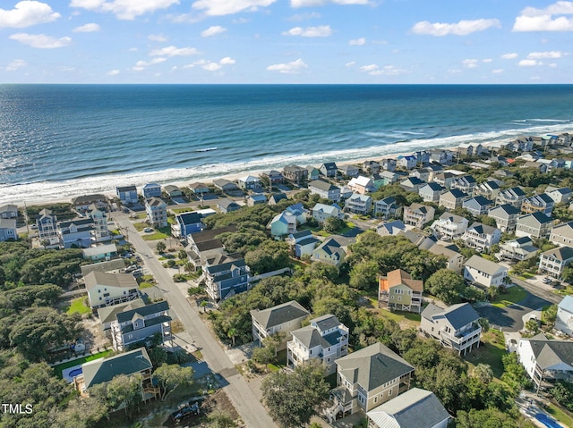 drone / aerial view featuring a water view and a view of the beach