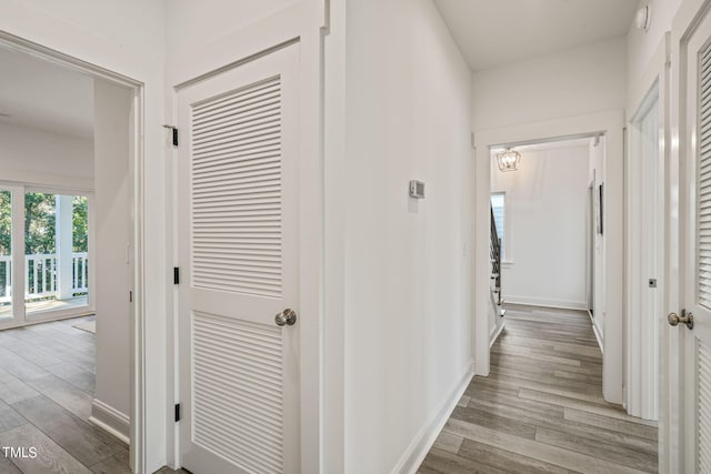 hallway with light hardwood / wood-style flooring