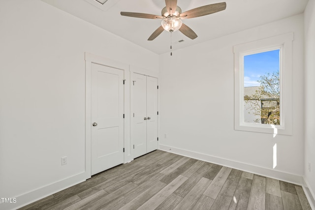 unfurnished bedroom with light wood-type flooring and ceiling fan